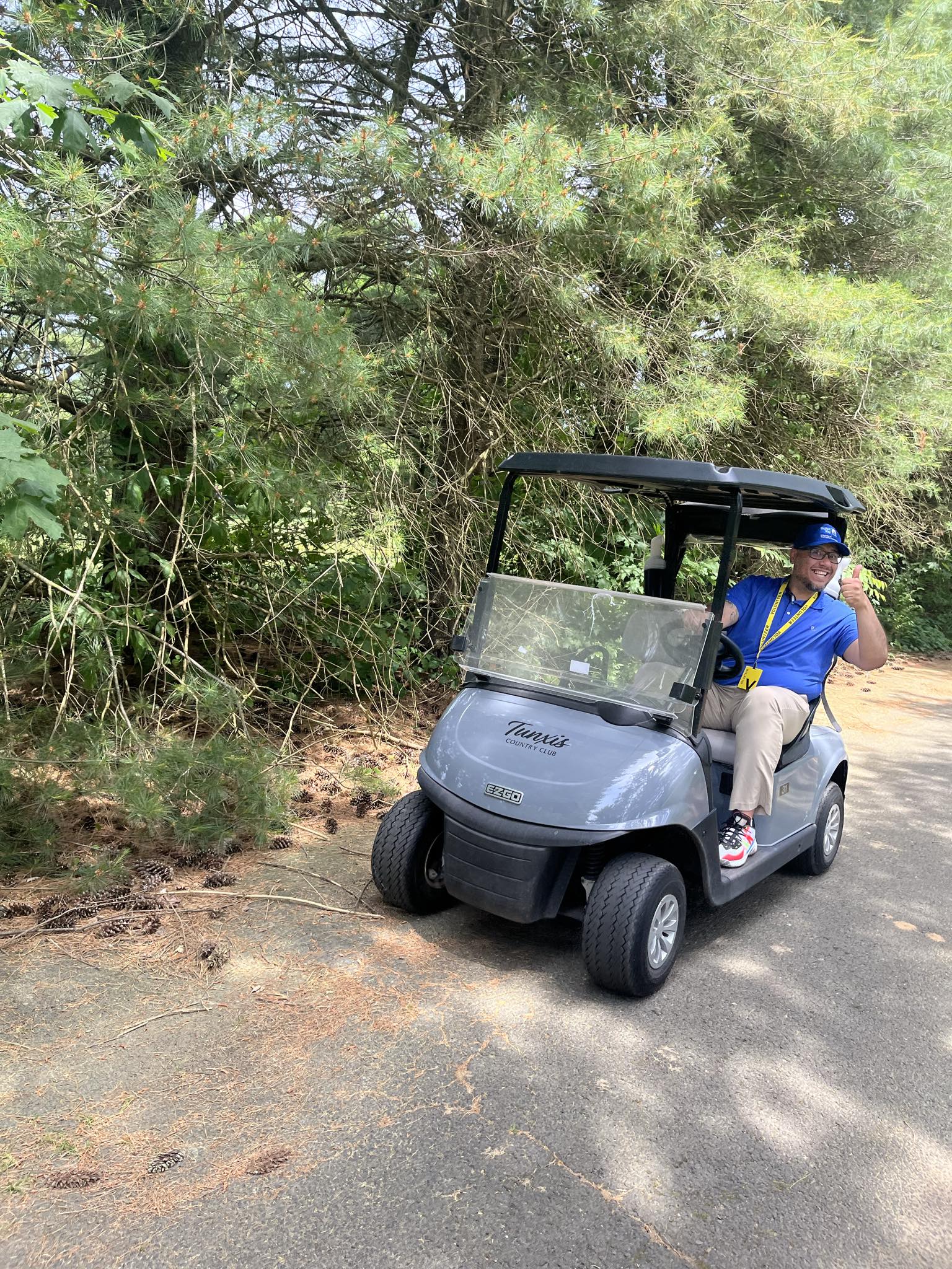 Manny Martinez President and CPO driving a golf cart