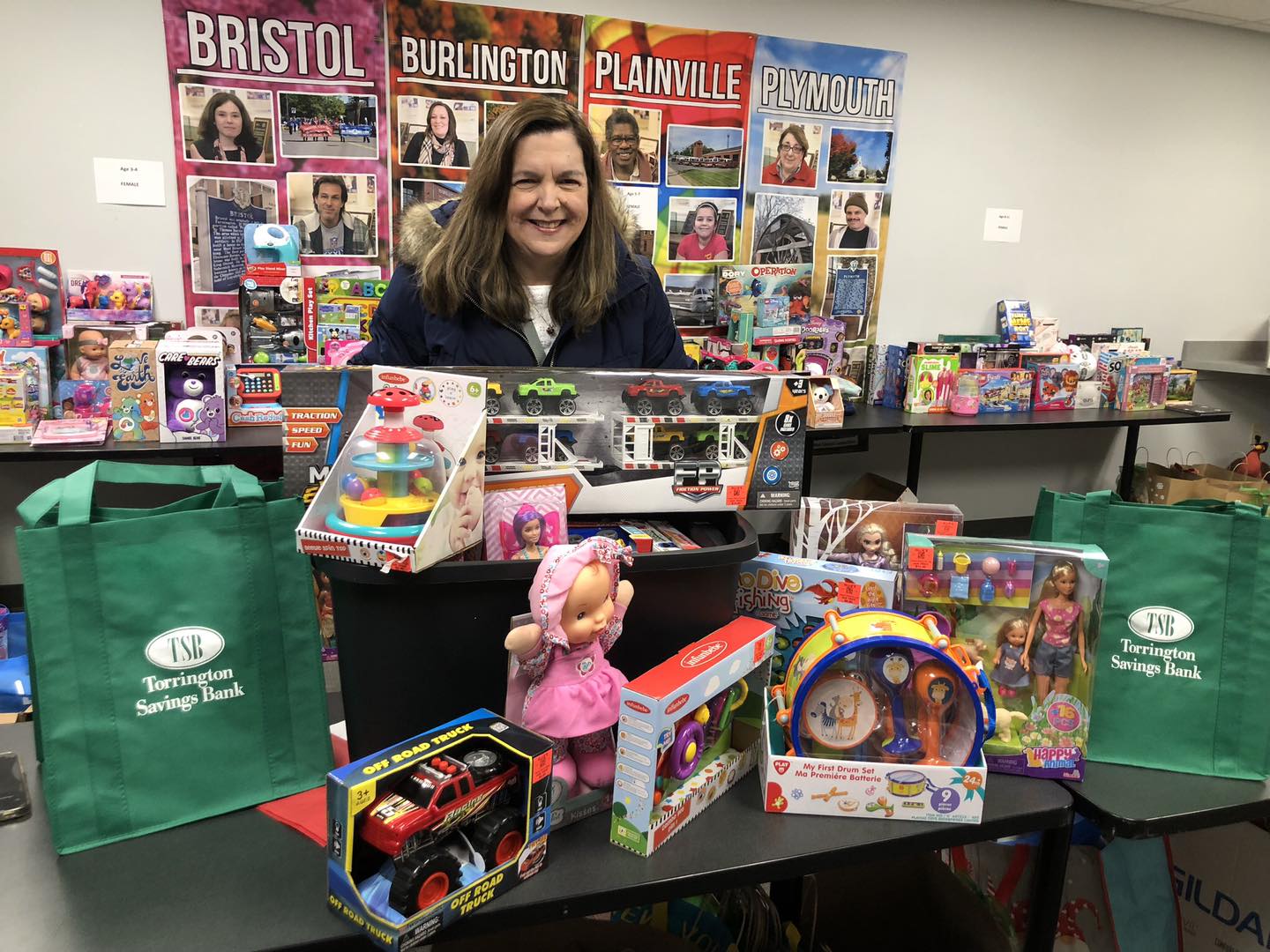 Woman standing at table with donation of toys